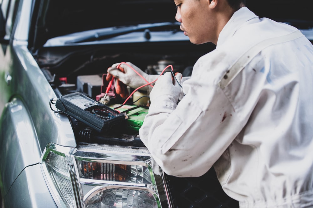 car-repairman-wearing-white-uniform-standing-holding-wrench-that-is-essential-tool-mechanic-min (1)
