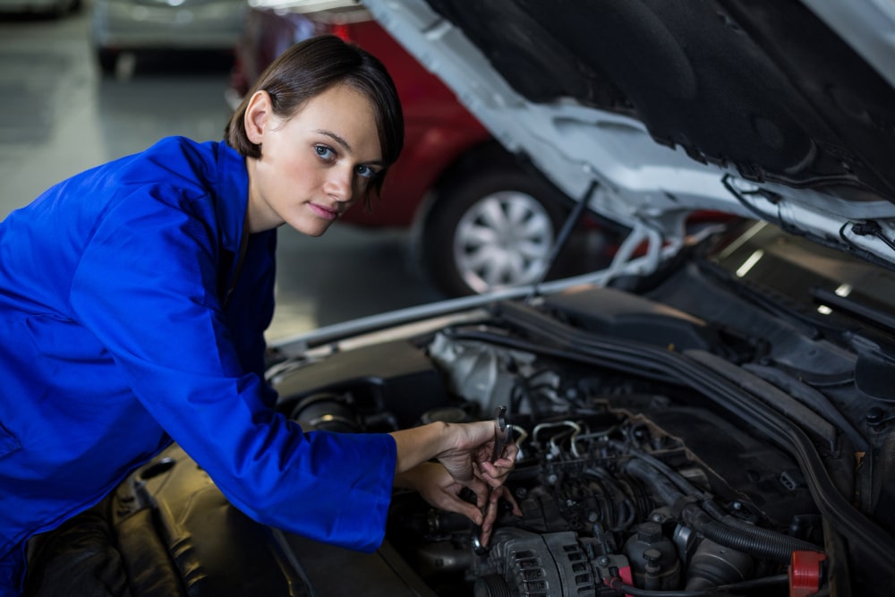 female-mechanic-servicing-car-min